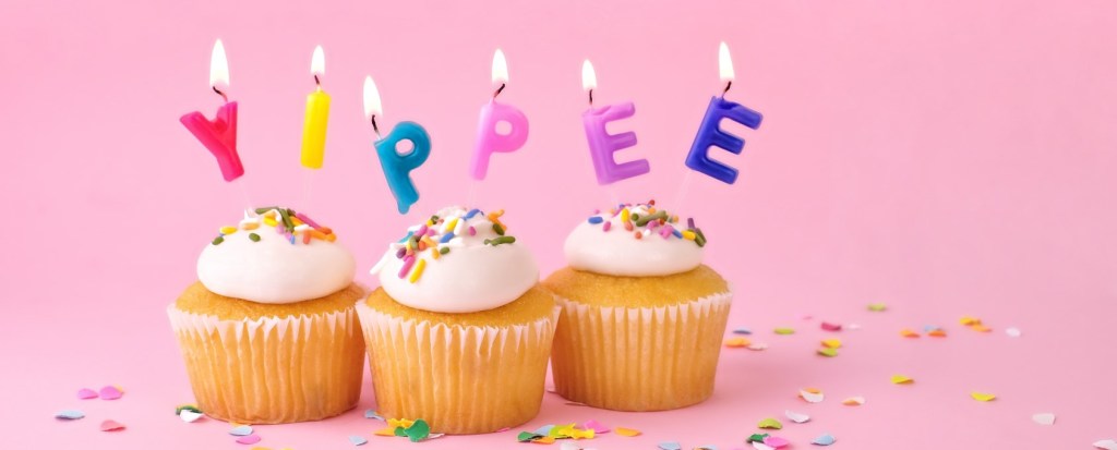 Three birthday cakes with candles