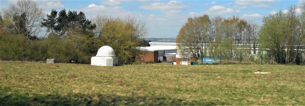 Photo of the proposed development site. Principally grassland with trees and scrub around edges. The latter, along with earth banks provided homes for rabbits, and other mammals.